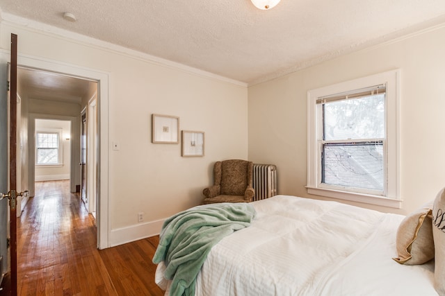 16924 Muirland St, Detroit, MI 48221 - bedroom featuring a textured ceiling, crown molding, hardwood / wood-style flooring, baseboards, and radiator heating unit