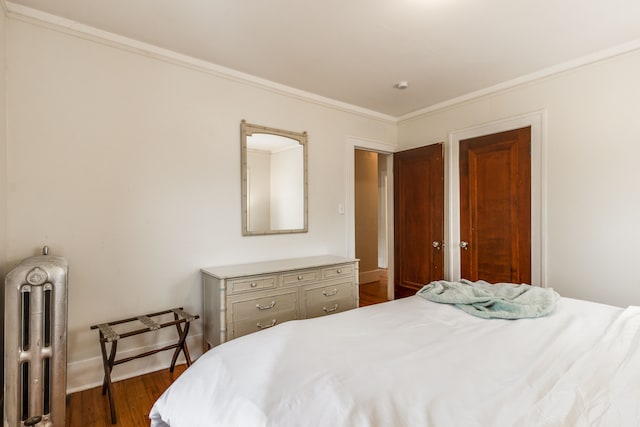 16924 Muirland St, Detroit, MI 48221 - bedroom featuring crown molding, baseboards, radiator heating unit, and dark wood-style floors