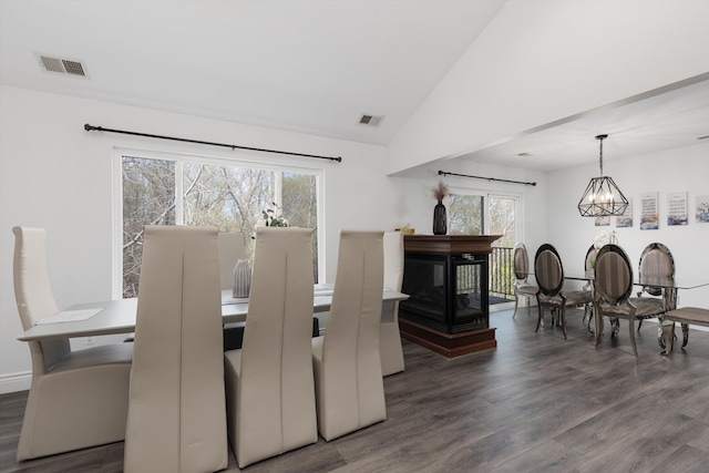 dining room featuring visible vents, wood finished floors, and an inviting chandelier