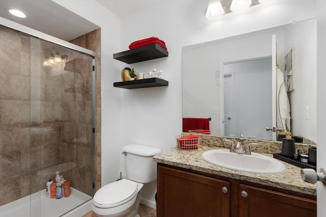 full bathroom with vanity, toilet, baseboards, and a stall shower