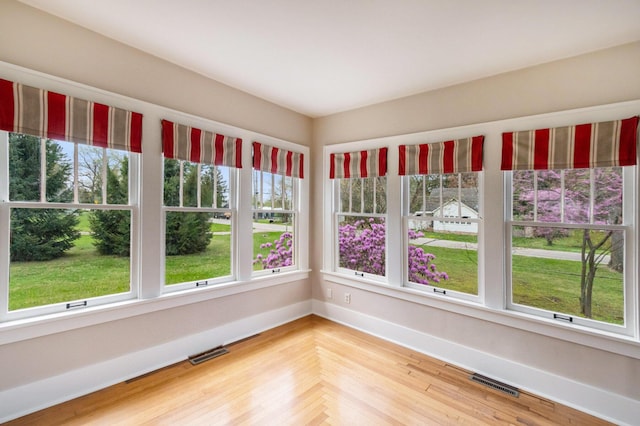 unfurnished sunroom featuring visible vents