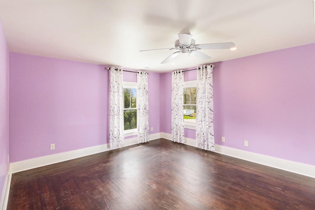 unfurnished room featuring a ceiling fan, baseboards, and wood finished floors