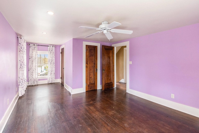 interior space with baseboards, a ceiling fan, and wood finished floors