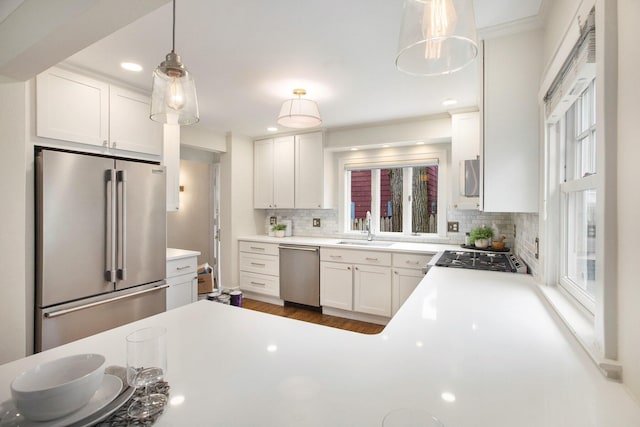 906 Granger Ave, Ann Arbor, MI 48104 - kitchen with dark wood-type flooring, tasteful backsplash, a sink, appliances with stainless steel finishes, and a wealth of natural light