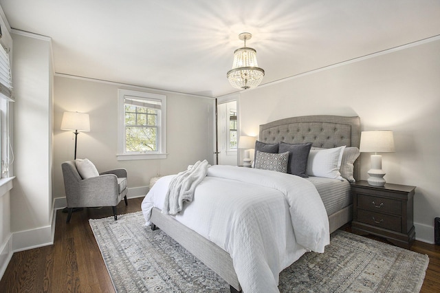906 Granger Ave, Ann Arbor, MI 48104 - bedroom featuring baseboards, a notable chandelier, and dark wood-style floors