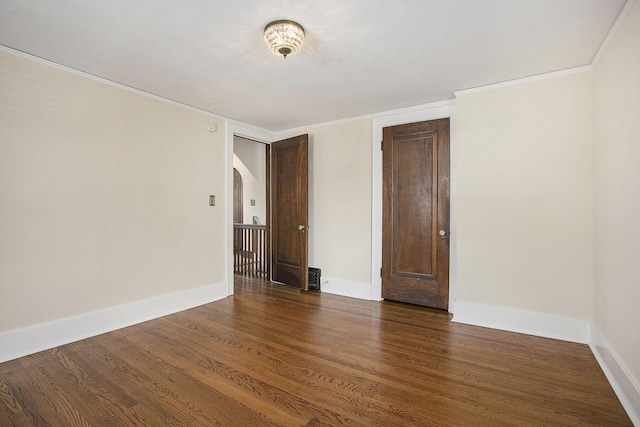 906 Granger Ave, Ann Arbor, MI 48104 - spare room with crown molding, baseboards, and dark wood finished floors