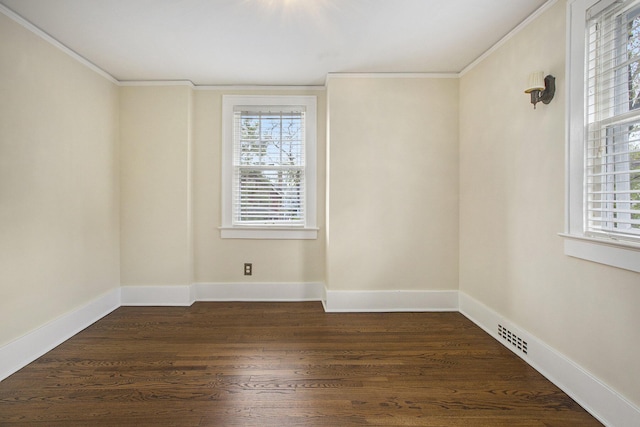 906 Granger Ave, Ann Arbor, MI 48104 - unfurnished room featuring crown molding, a healthy amount of sunlight, dark wood-type flooring, and visible vents