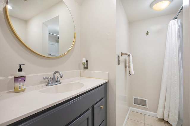 906 Granger Ave, Ann Arbor, MI 48104 - bathroom with tile patterned flooring, vanity, baseboards, a shower with curtain, and visible vents