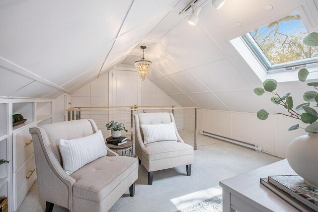 906 Granger Ave, Ann Arbor, MI 48104 - living area featuring a baseboard heating unit, vaulted ceiling with skylight, and light carpet