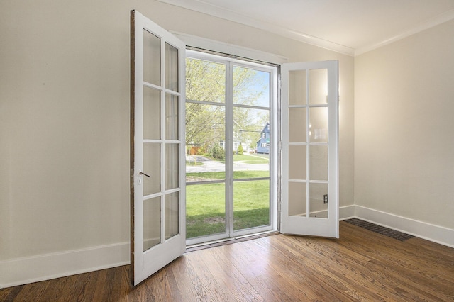 906 Granger Ave, Ann Arbor, MI 48104 - doorway to outside with visible vents, ornamental molding, baseboards, and wood finished floors