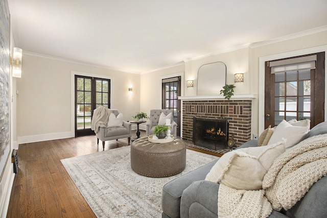 906 Granger Ave, Ann Arbor, MI 48104 - living area with crown molding, baseboards, a brick fireplace, and hardwood / wood-style floors