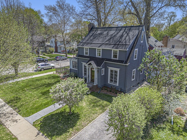 906 Granger Ave, Ann Arbor, MI 48104 - view of front of home featuring a residential view, roof with shingles, a front yard, and a chimney