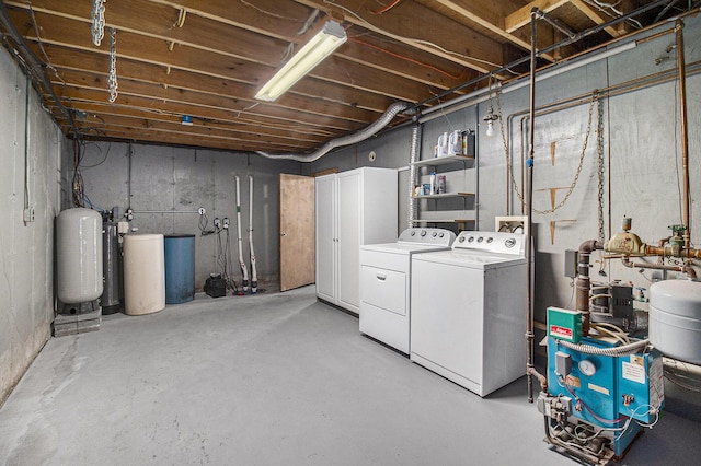 unfinished basement with washing machine and clothes dryer and a water softener system