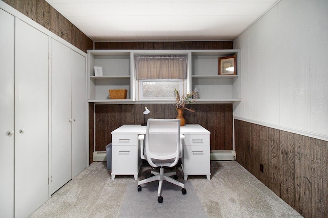 office space with light carpet, baseboard heating, wood walls, and a baseboard radiator