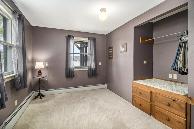 carpeted bedroom with a baseboard radiator and baseboards