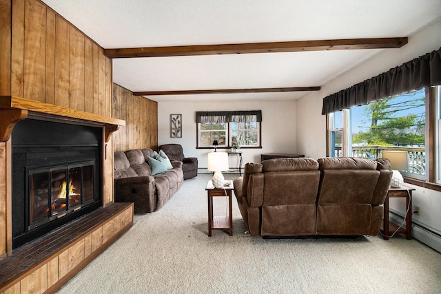 living room featuring light colored carpet, beamed ceiling, a large fireplace, and wood walls