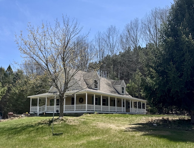 view of front of house with covered porch and a front yard