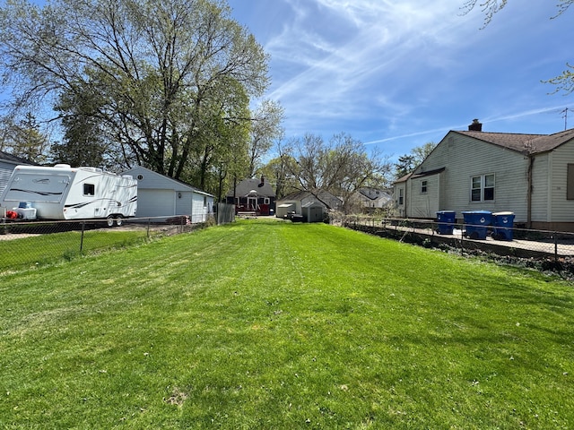 2361 Montroyal Ave, Waterford, MI 48328 - view of yard featuring a garage, fence, and a residential view