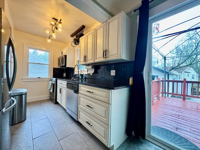 2361 Montroyal Ave, Waterford, MI 48328 - kitchen with dark countertops, baseboards, tasteful backsplash, a sink, and stainless steel appliances