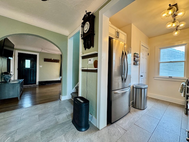 2361 Montroyal Ave, Waterford, MI 48328 - kitchen with baseboards, arched walkways, a textured ceiling, and freestanding refrigerator