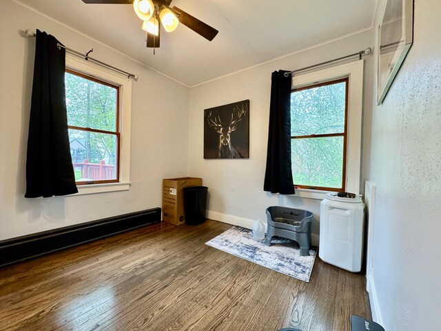 2361 Montroyal Ave, Waterford, MI 48328 - interior space with a ceiling fan, baseboards, wood finished floors, a baseboard radiator, and ornamental molding