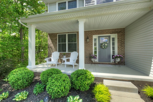 3088 Painted Dr, Howell, MI 48843 - doorway to property with a porch and brick siding
