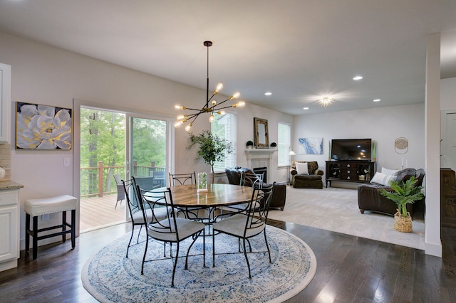 3088 Painted Dr, Howell, MI 48843 - dining area with plenty of natural light, dark wood-type flooring, a chandelier, a fireplace, and recessed lighting