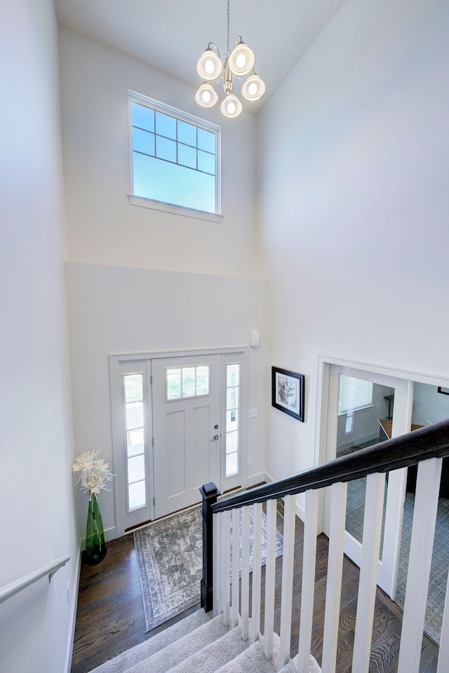 3088 Painted Dr, Howell, MI 48843 - foyer featuring a high ceiling, plenty of natural light, stairs, and wood finished floors