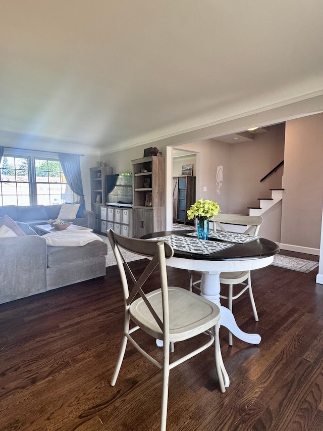 dining room with baseboards, stairs, and dark wood-type flooring
