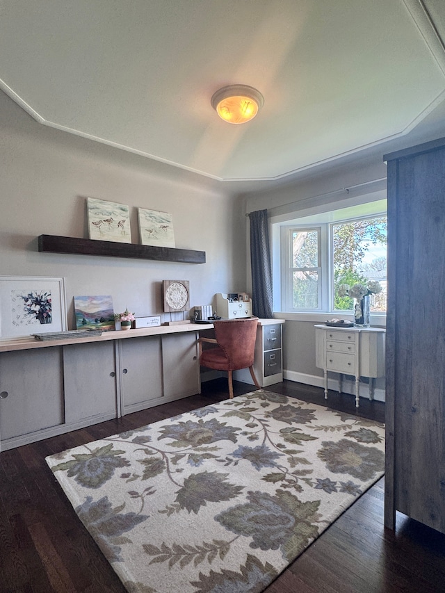 office space featuring dark wood-style flooring and built in desk