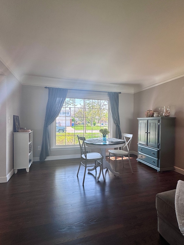 dining area featuring baseboards, crown molding, and dark wood-type flooring