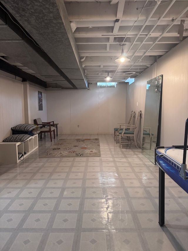 finished below grade area featuring light floors