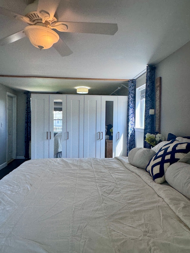 bedroom with multiple windows and ceiling fan
