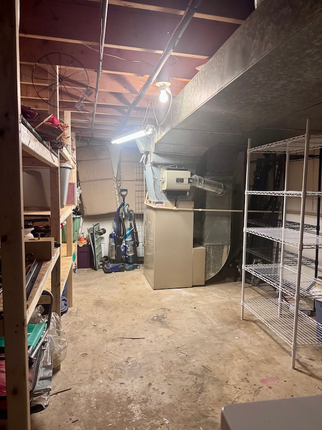 unfinished basement featuring heating unit