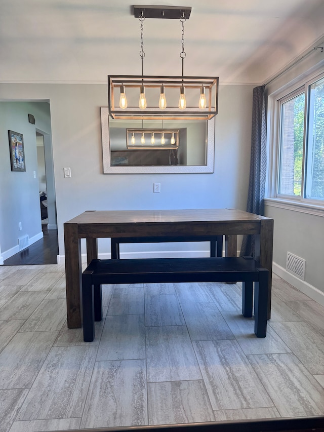 dining space featuring baseboards, visible vents, and wood finished floors