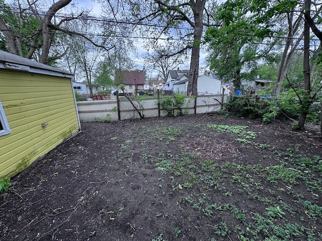 view of yard featuring fence and a residential view