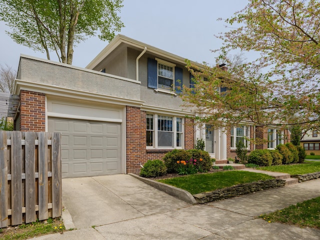 view of front of house featuring a garage, fence, stucco siding, brick siding, and concrete driveway