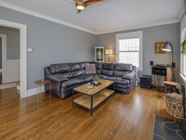 living room featuring ornamental molding and wood finished floors