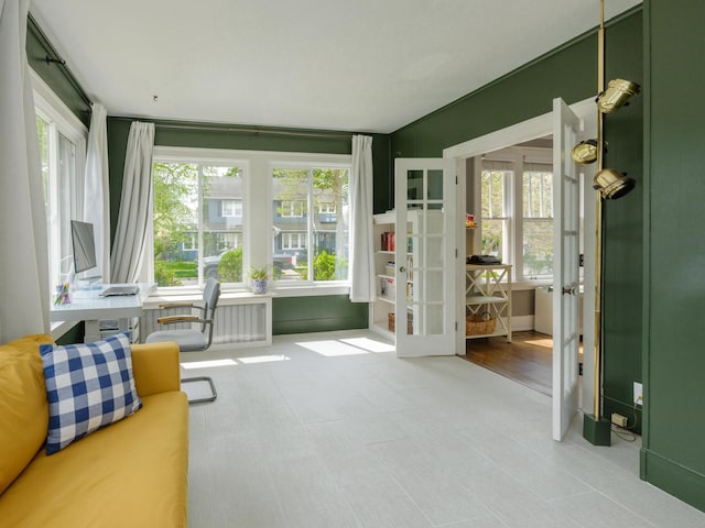 sunroom featuring french doors and a healthy amount of sunlight