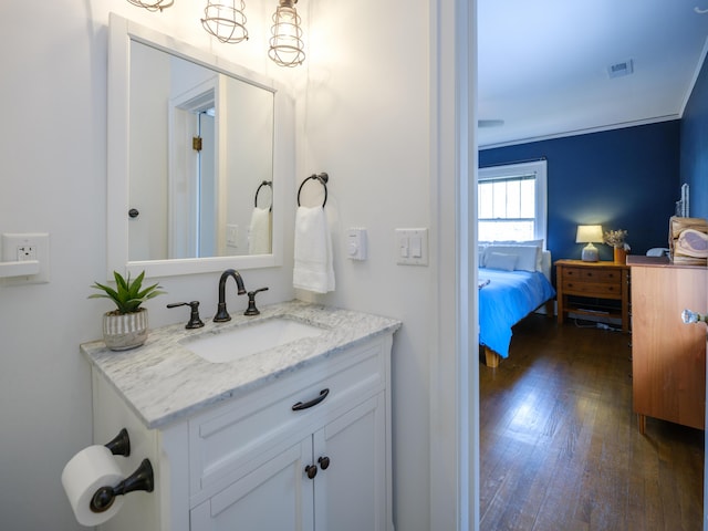 bathroom featuring wood-type flooring, visible vents, and vanity