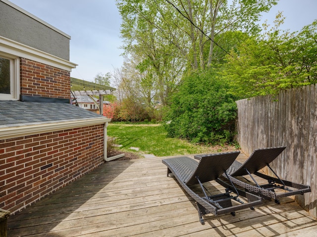 wooden deck with a lawn