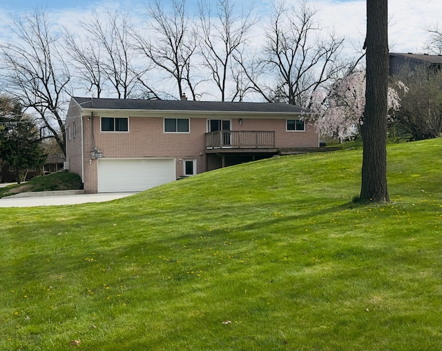 view of front facade featuring an attached garage, concrete driveway, a front lawn, and brick siding