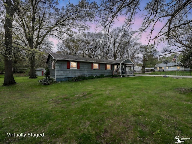 single story home featuring fence, a yard, and covered porch