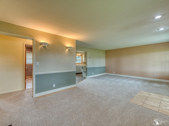 carpeted spare room featuring recessed lighting and baseboards