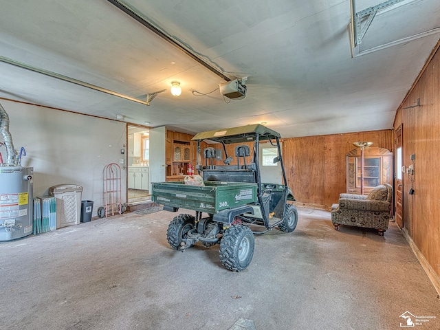 garage with a garage door opener, water heater, and wooden walls