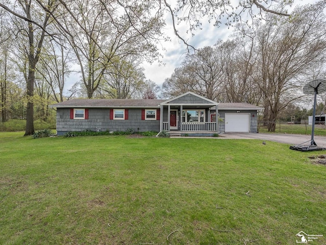 ranch-style house featuring a garage, a front lawn, covered porch, and driveway