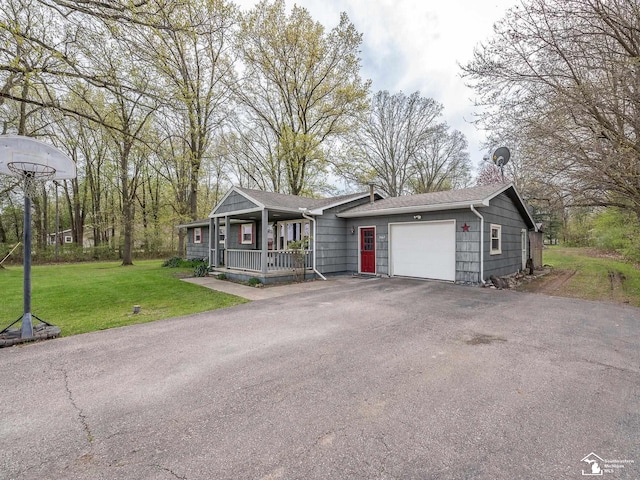 ranch-style house with covered porch, driveway, roof with shingles, a garage, and a front lawn