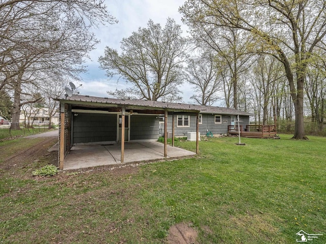 rear view of house featuring a yard and a deck