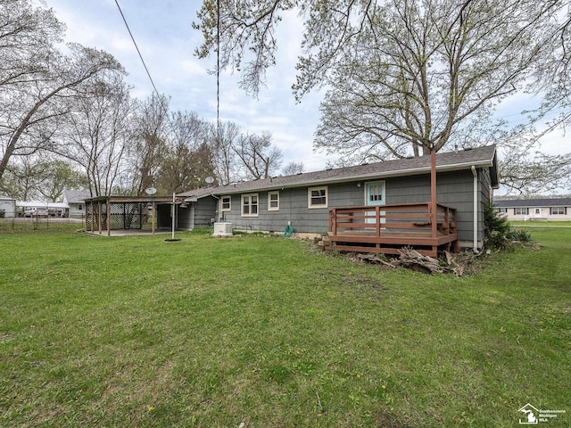 back of house with a yard and a deck
