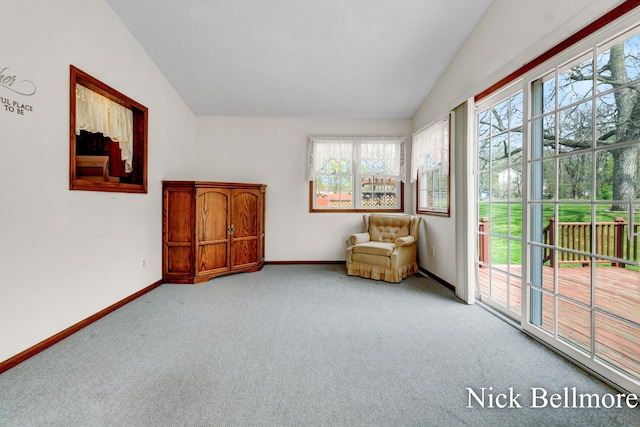 sitting room featuring plenty of natural light, carpet, baseboards, and vaulted ceiling